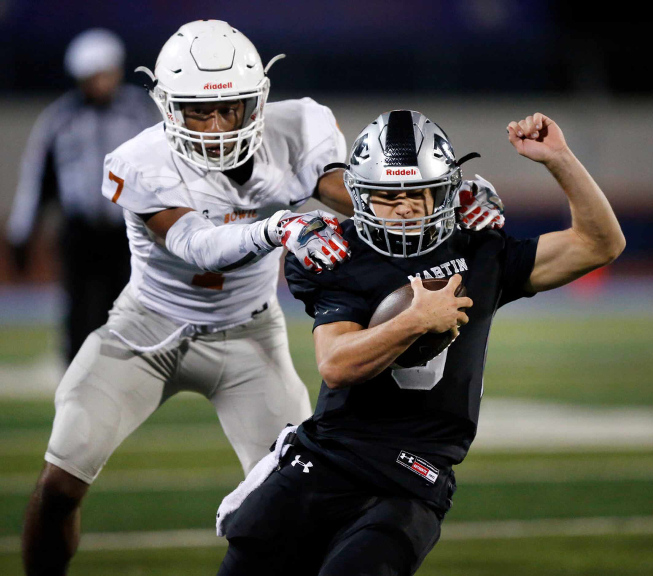 On a fourth down play, Martin High quarterback Zach Mundell (6) picks up the first down as...