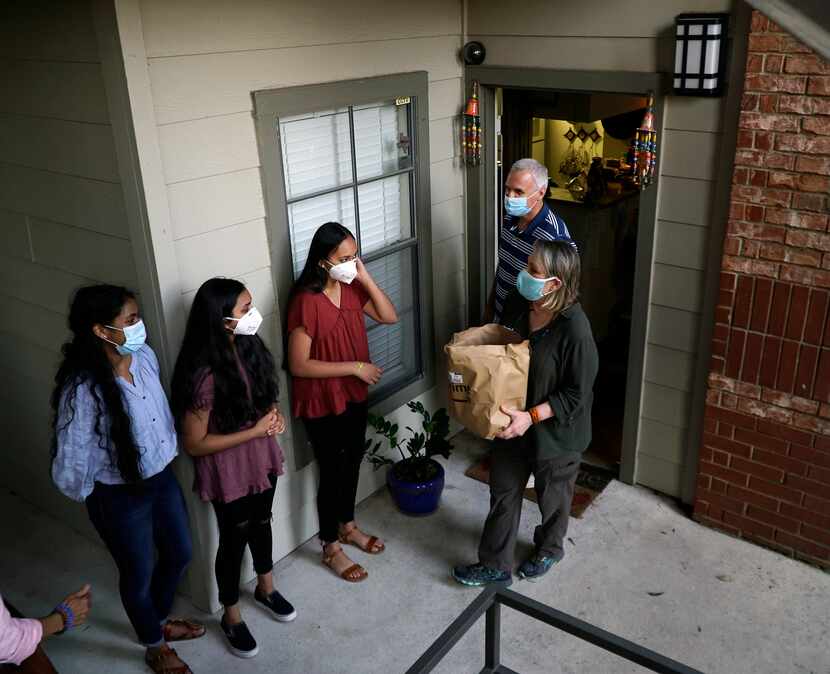 Eric and Shakti Biskamp receive sandwiches and other supplies from friends at their home in...