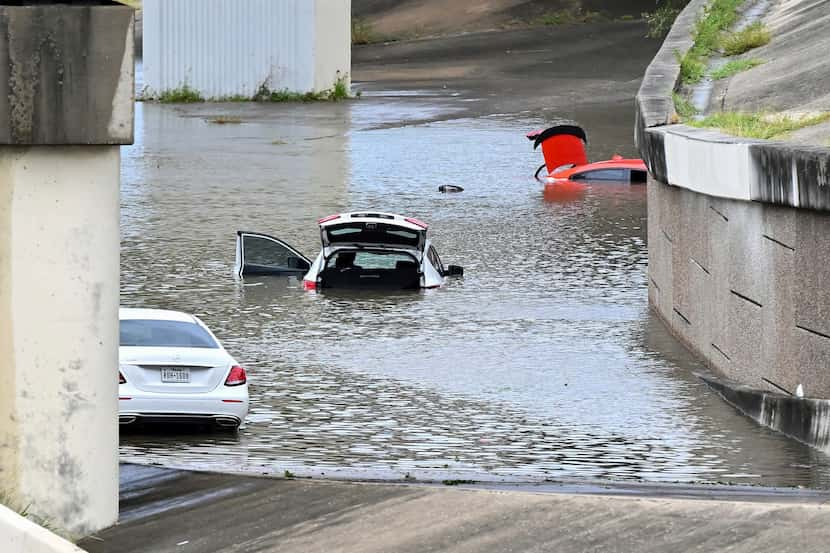 Buffalo Bayou floods stranding vehicles near Downtown Houston after Beryl came ashore in...