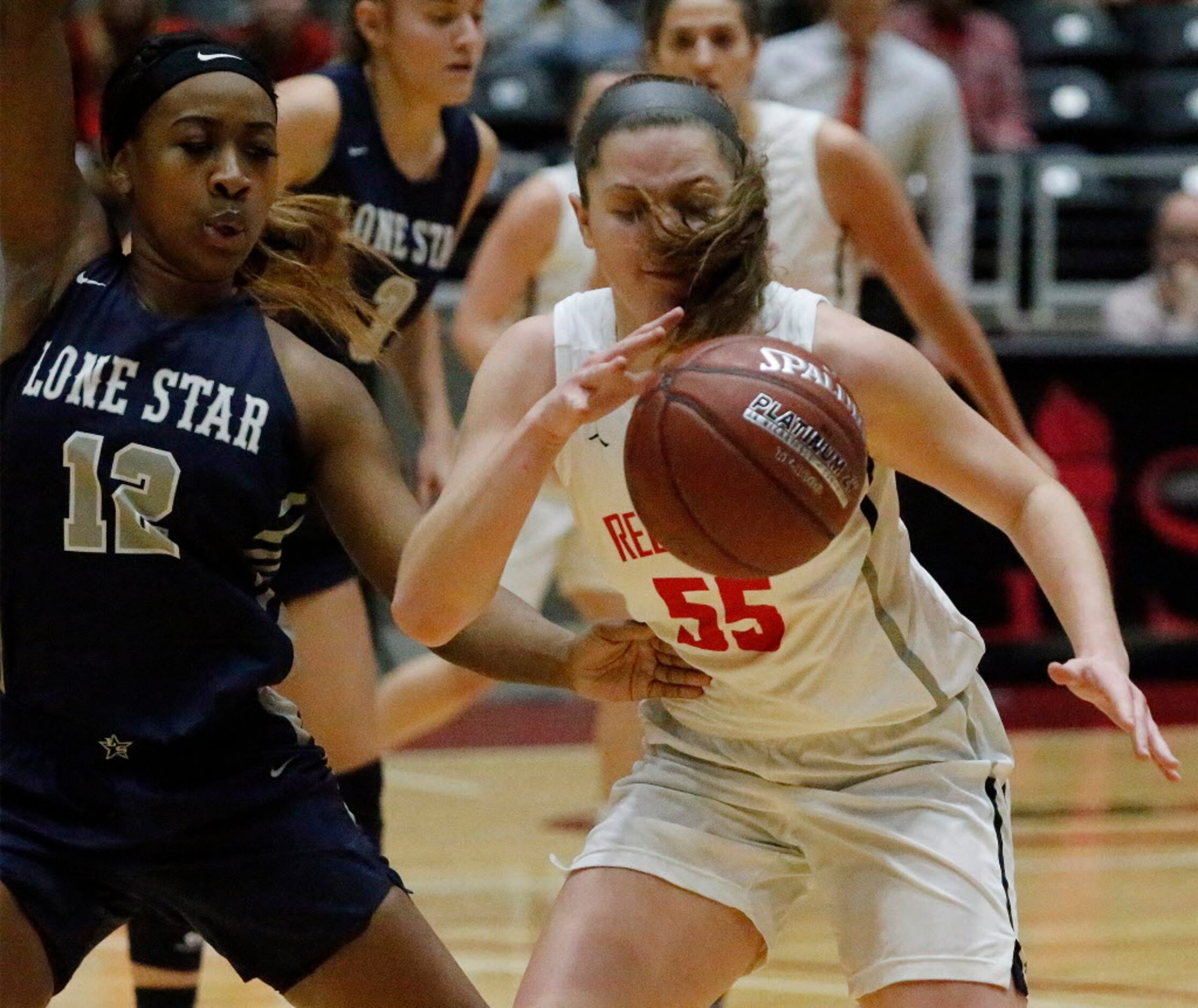 Liberty High School guard Kelsey Kurak (55) tries to see through her pony tail while being...