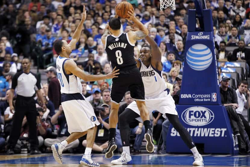Brooklyn Nets guard Deron Williams (8) tries to drive against Dallas Mavericks guard Devin...