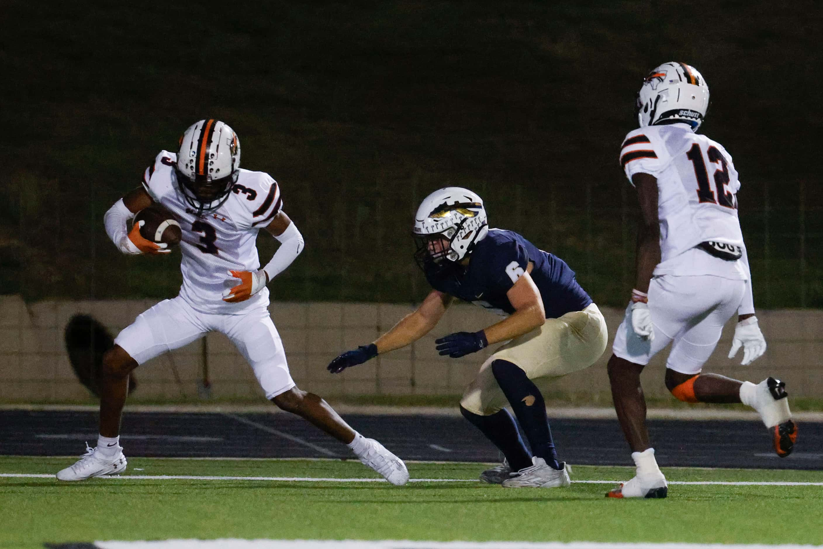 Haltom high’s Darius Harkless (left) intercepts a touchdown pass intended for Keller High’s...