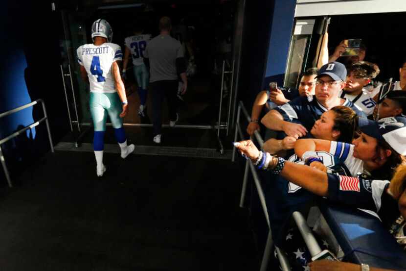Dallas Cowboys quarterback Dak Prescott (4) walks to the locker room after running out of...
