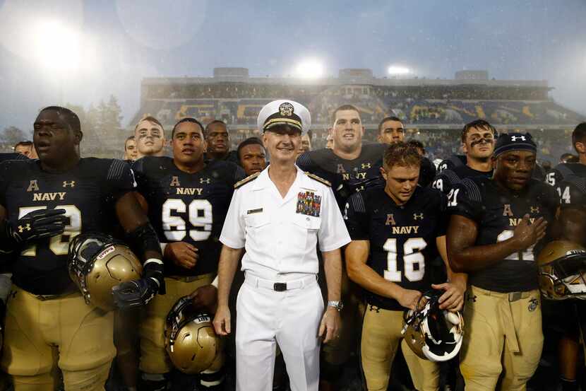 U.S. Naval Academy superintendent Ted Carter, center, stands with Navy players after an NCAA...