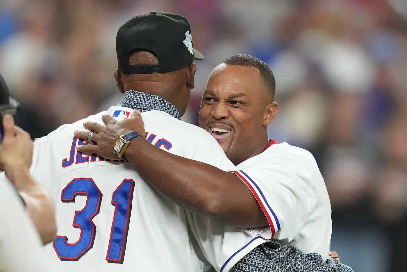 Former Texas Rangers pitcher Fergie Jenkins embraces former third baseman Adrián Beltré...