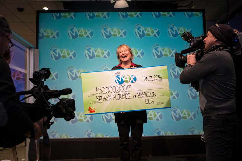 Kathryn Jones faces the cameras with a promotional check for the $50 million (Canadian) she...