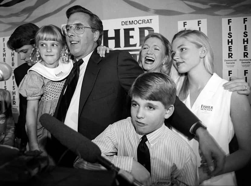 Richard Fisher and his family celebrate after he defeated Jim Mattox in the Democratic...