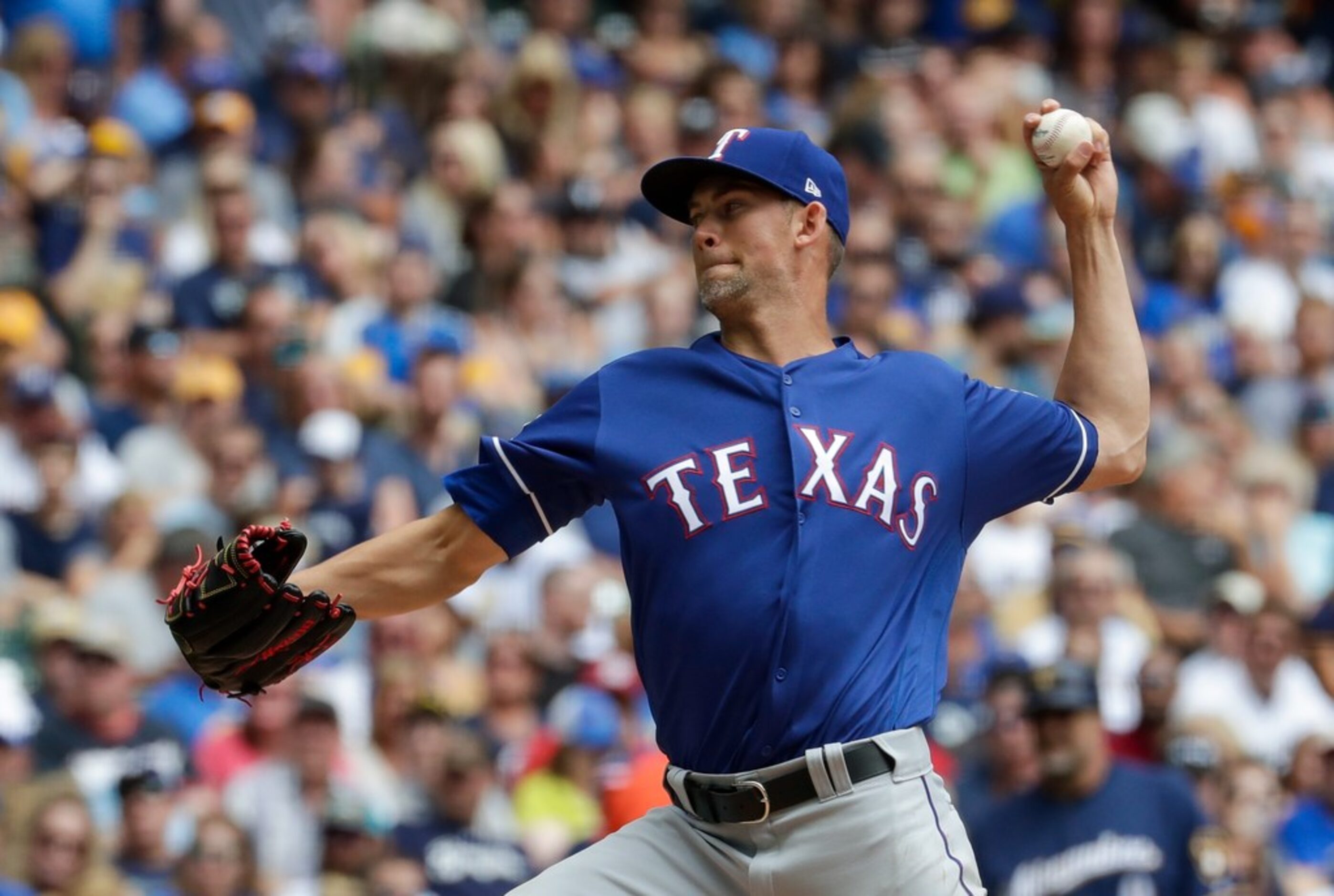 Texas Rangers starting pitcher Mike Minor throws during the first inning of a baseball game...