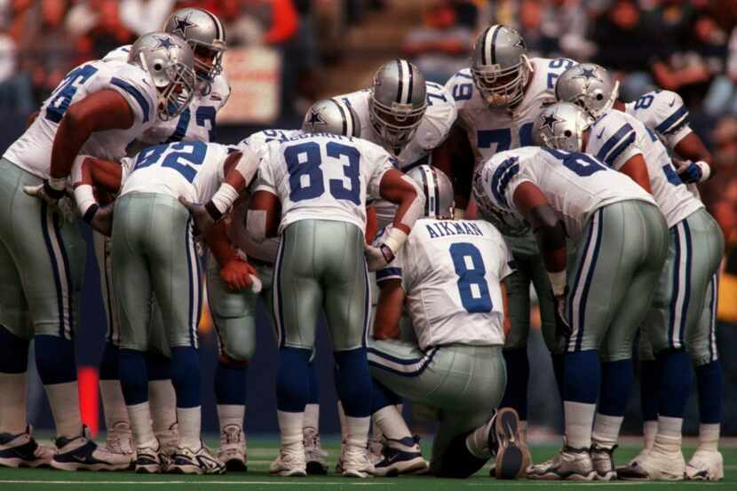 ORG XMIT: The Dallas offense huddles around Troy Aikman as he calls the play against the...