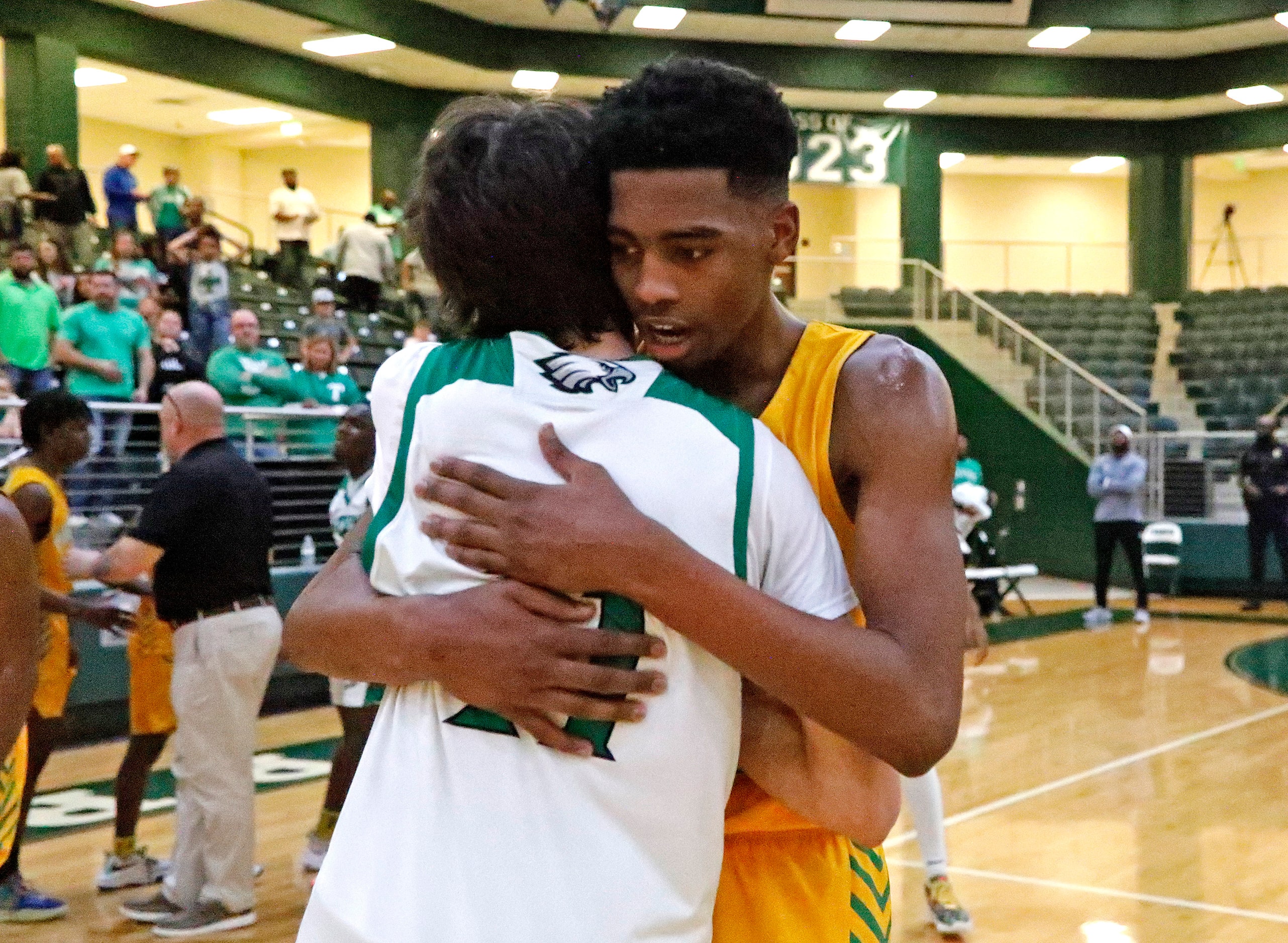 Tatum gaurd Aidan Anthony (11) embraces Madison forward Rodney Geter (13) after Madison won...