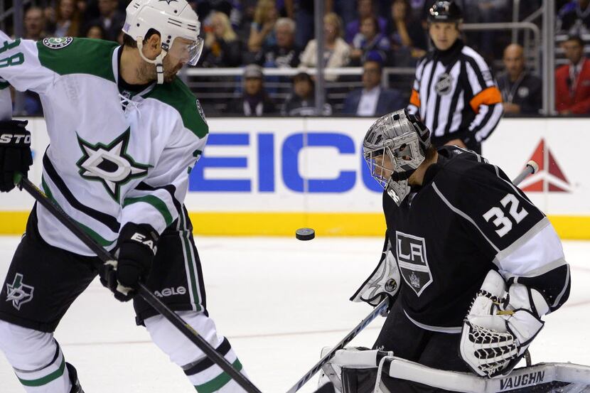 Los Angeles Kings goalie Jonathan Quick, right, stops a shot as Dallas Stars center Vernon...