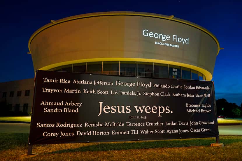 A banner reading "Jesus weeps: bearing the names of Black people killed by police or other...