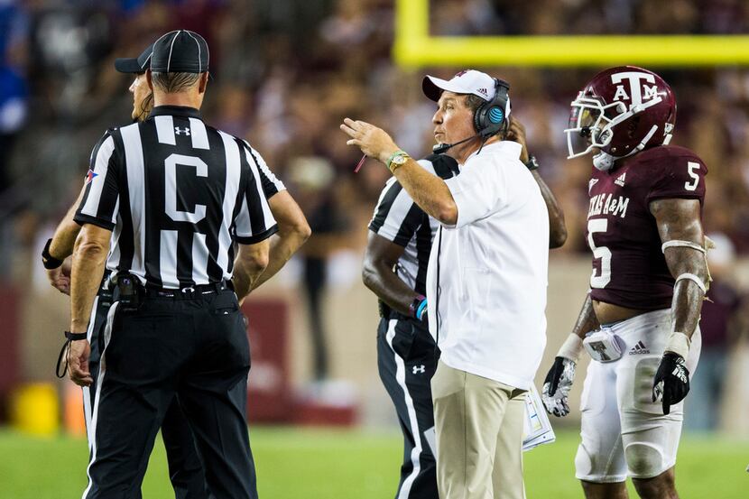 Texas A&M Aggies head coach Jimbo Fisher talks to officials about the rules of overtime...