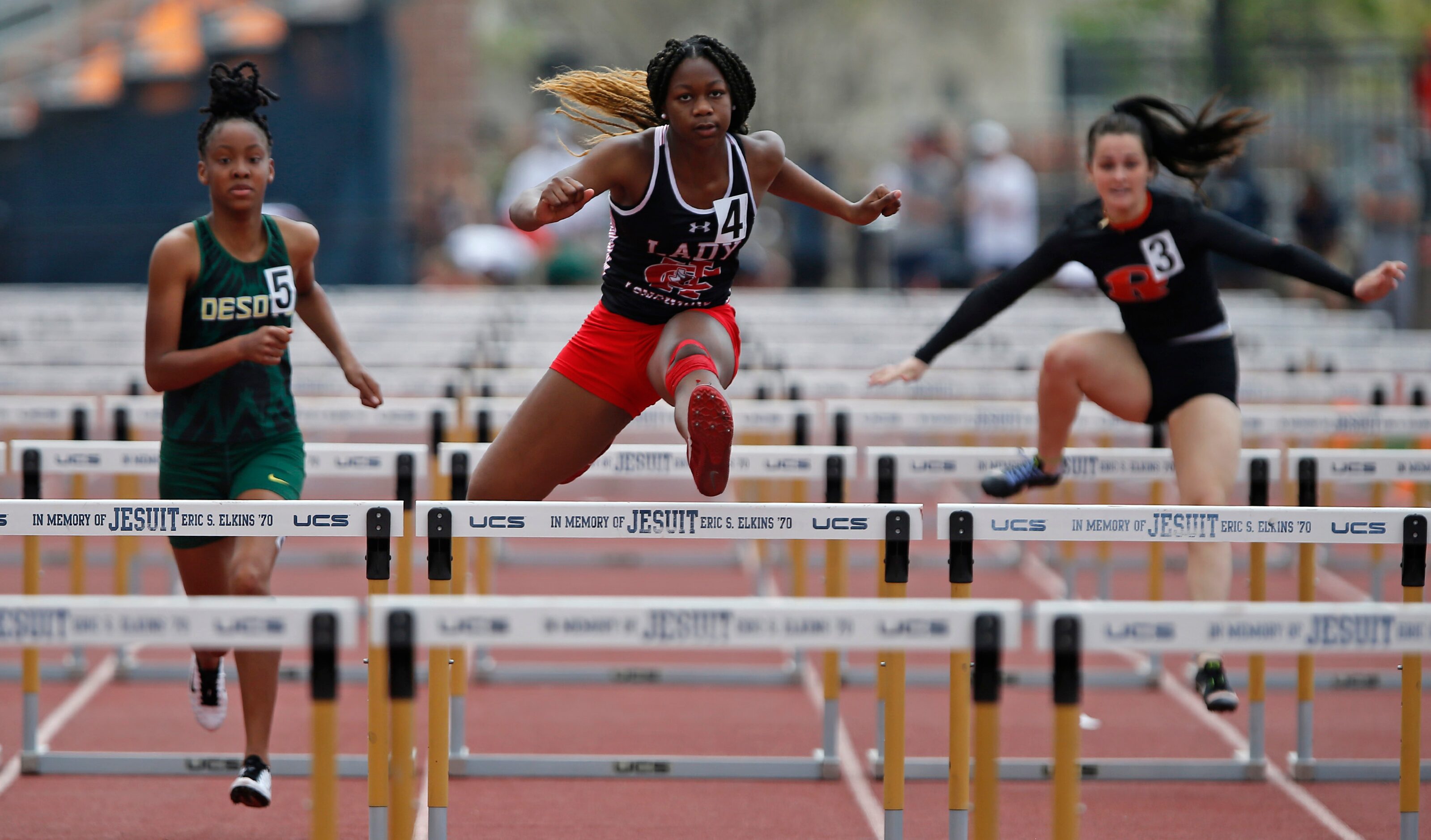 Cedar Hill High School’s Charidee Morgan (center), 15, won her heat in the 100 hurdles...