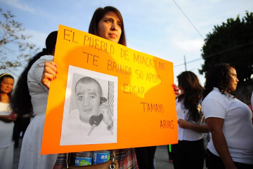 In this Jan. 19, 2014 photo, a woman holds up a sign showing a photo of Texas death-row...