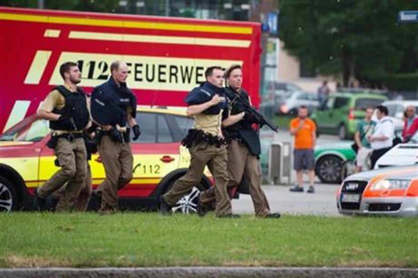 Policemen arrive at a shopping centre in which a shooting was reported in Munich, southern...