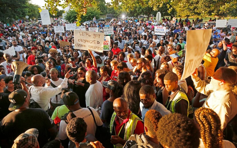 
Local author David Lee (with microphone) addressed a crowd of about 500 protesters Monday...