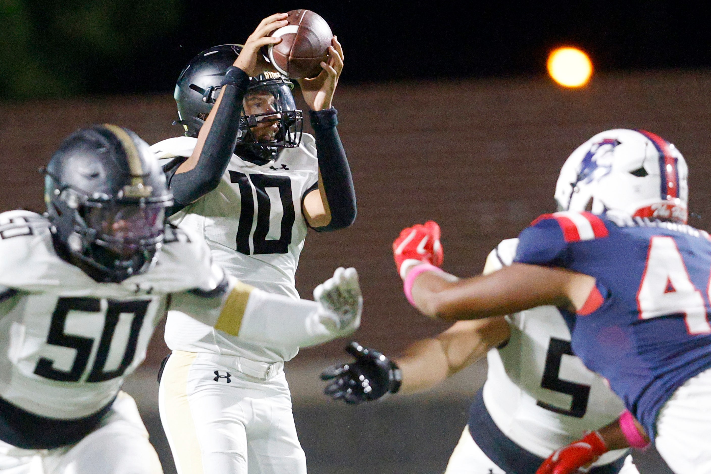 Fossil Ridge's quarterback Malaki Lockhart (10) looks to throw the ball under pressure from...