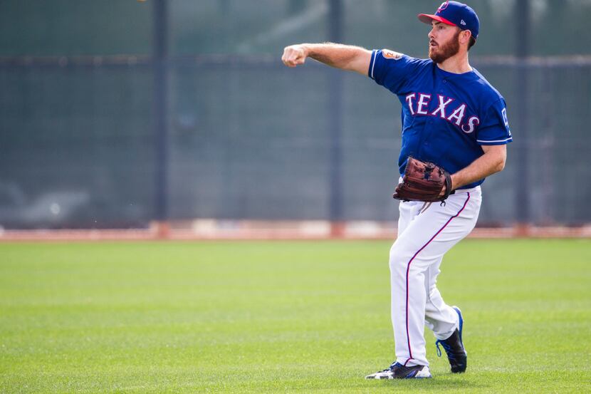 Texas Rangers relief pitcher Sam Dyson (47) plays catch in the outfield during a spring...