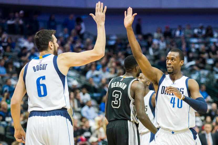 Dallas Mavericks center Andrew Bogut (6) high-fives forward Harrison Barnes (40) after...