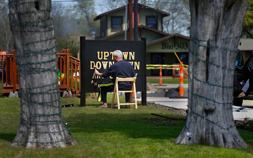 
Co-founder Jim Kuntz paints the new Uptown Downtown Art Gallery and Studio sign. 
