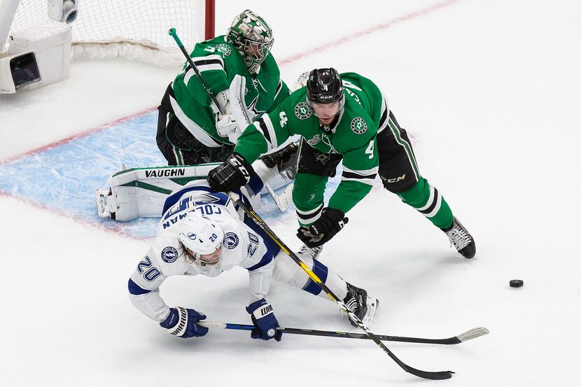 Miro Heiskanen (4) of the Dallas Stars battles against Blake Coleman (20) of the Tampa Bay...