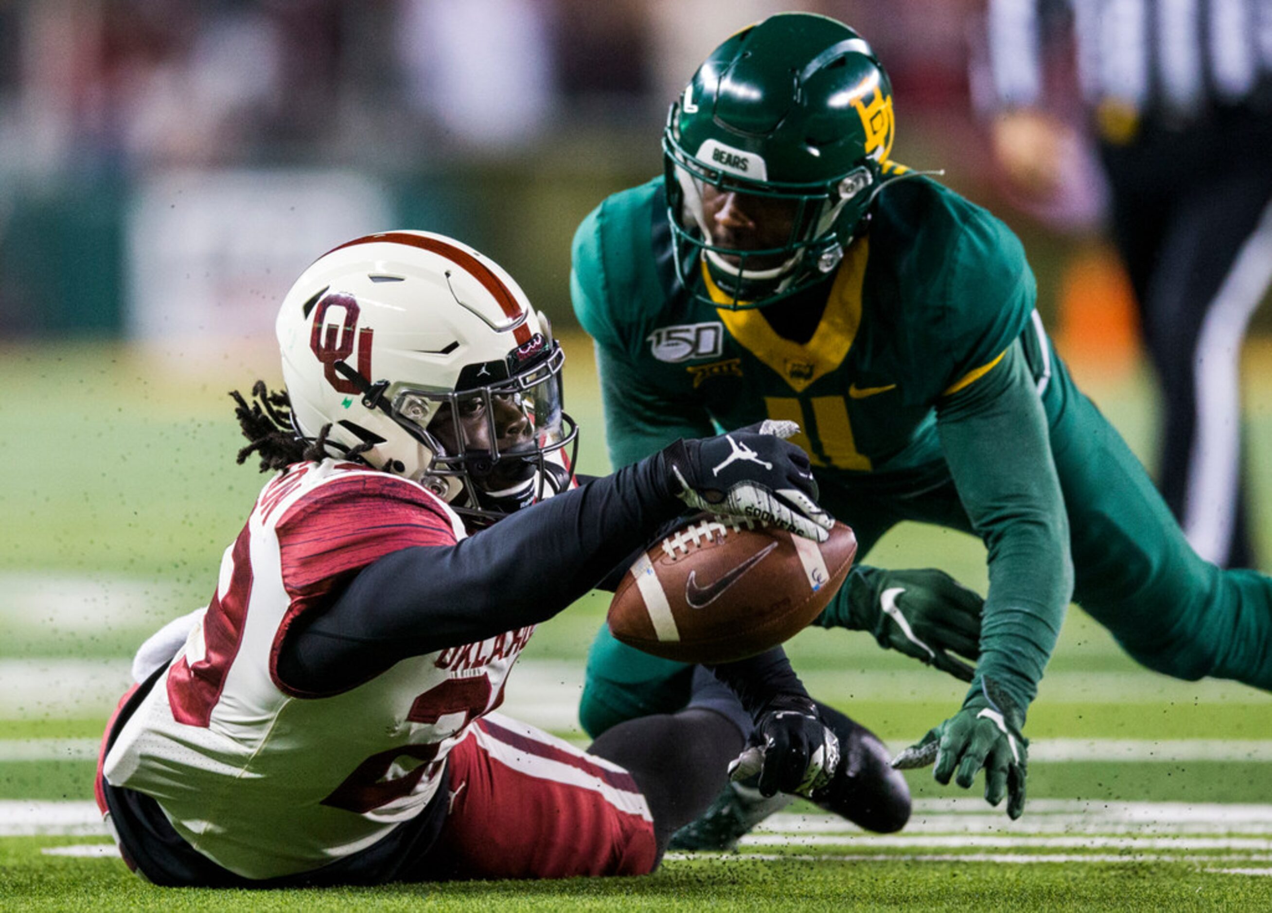 Oklahoma Sooners running back Rhamondre Stevenson (29) recovers his own fumble near Baylor...