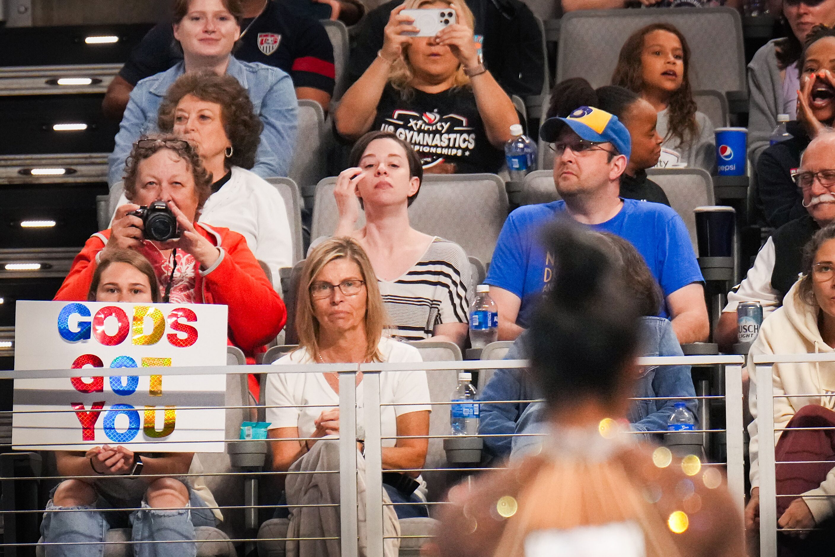 Fans hold signs for Simone Biles as she prepares to compete on the floor during the U.S....