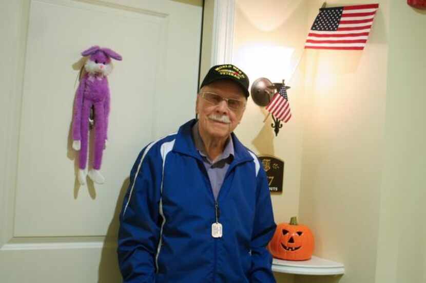 World War II veteran Paul Fouts, 97, displays the American flag outside his apartment at The...