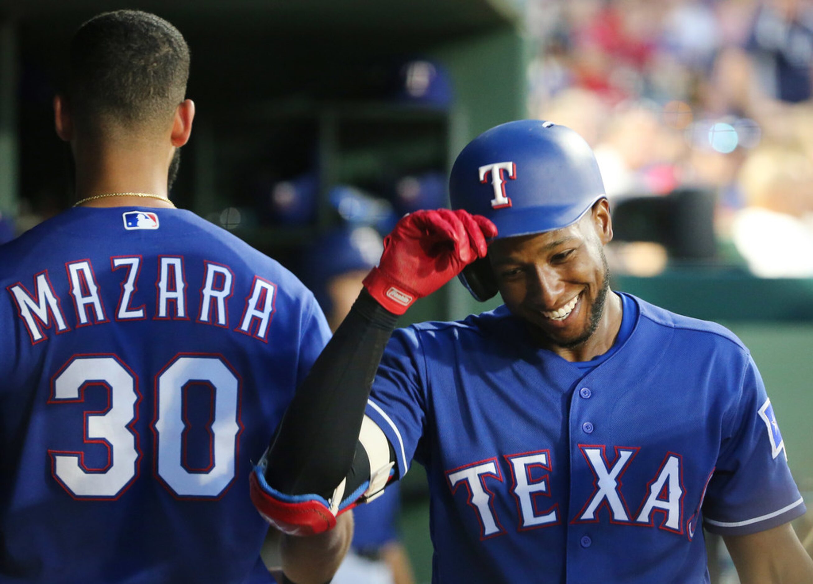 Texas Rangers shortstop Jurickson Profar (19) celebrates after hitting a home run to make...