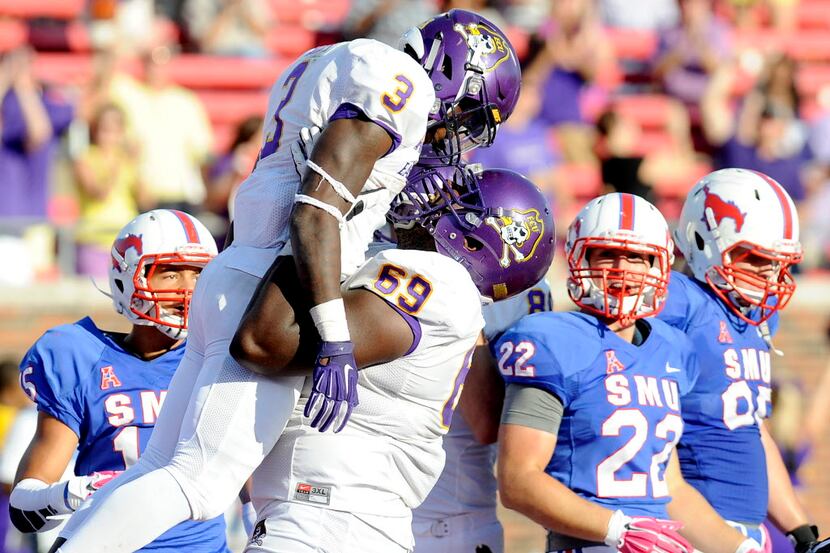 East Carolina Pirates running back Anthony Scott (3) and offensive lineman Ike Harris (69)...