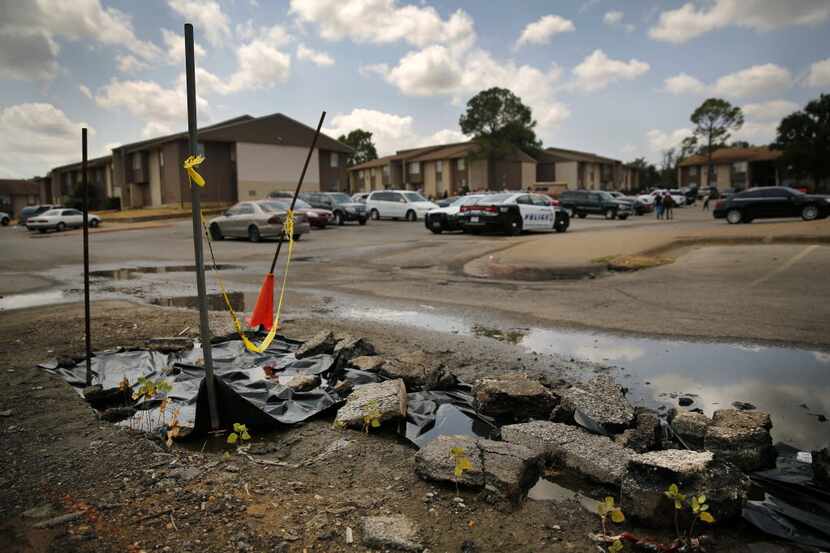  Cars driving through the Asante Apartment Homes complex have to dodge this damaged part of...