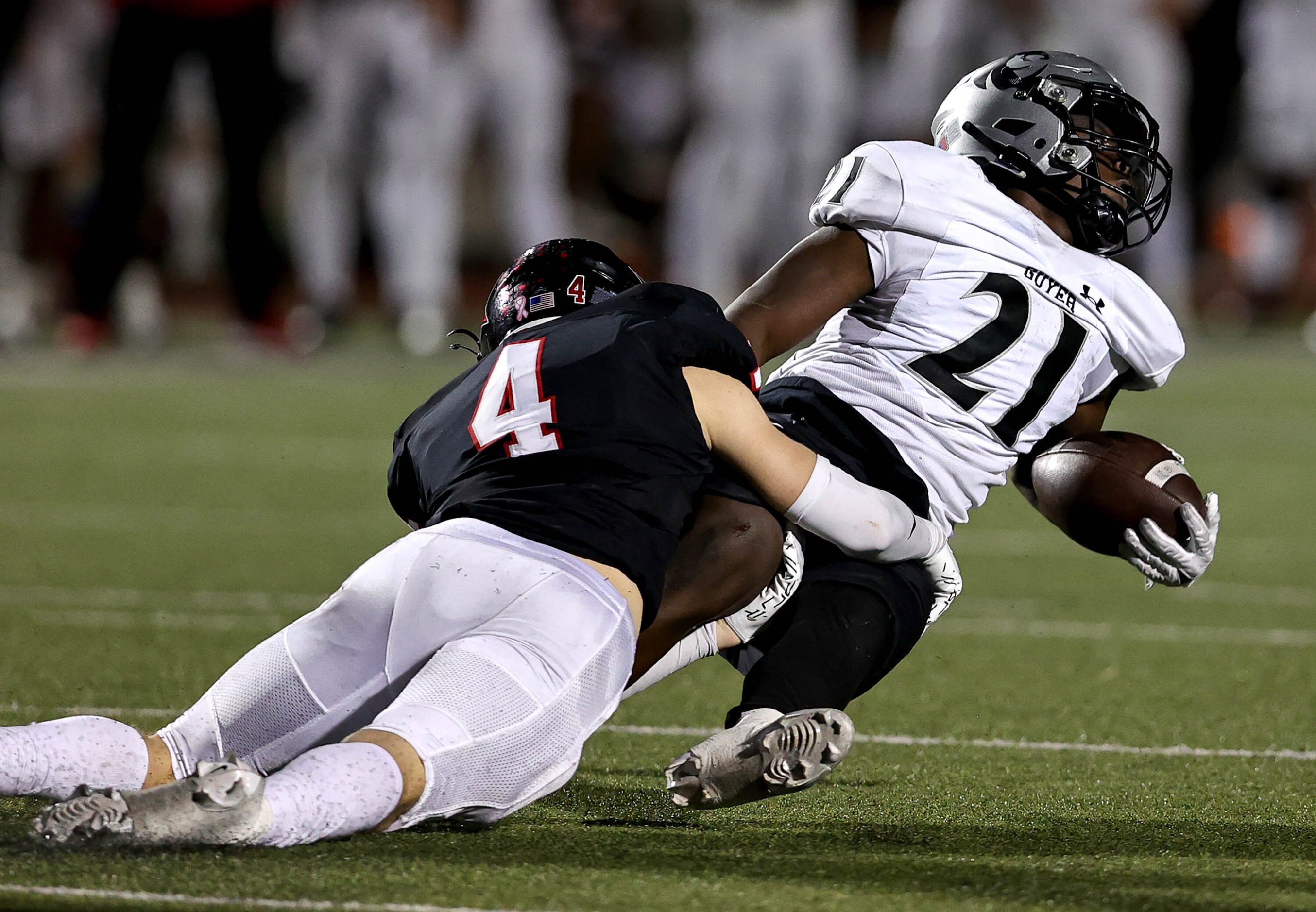 Denton Guyer running back Ahmed Yussuf (21) gets brought down by Coppell safety Scott...