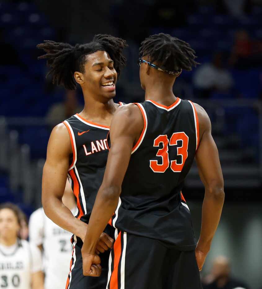 Lancaster's Dillon Battie (4) celebrates with teammate Amari Reed (33) after a dunk in the...
