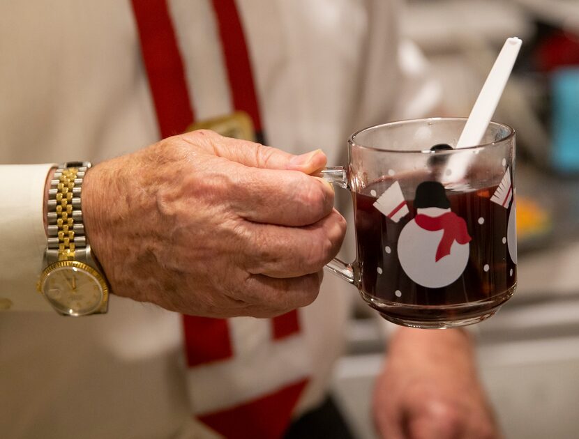 Kenneth Wincorn holds a cup of glogg, a traditional Danish mulled wine with chopped almonds...