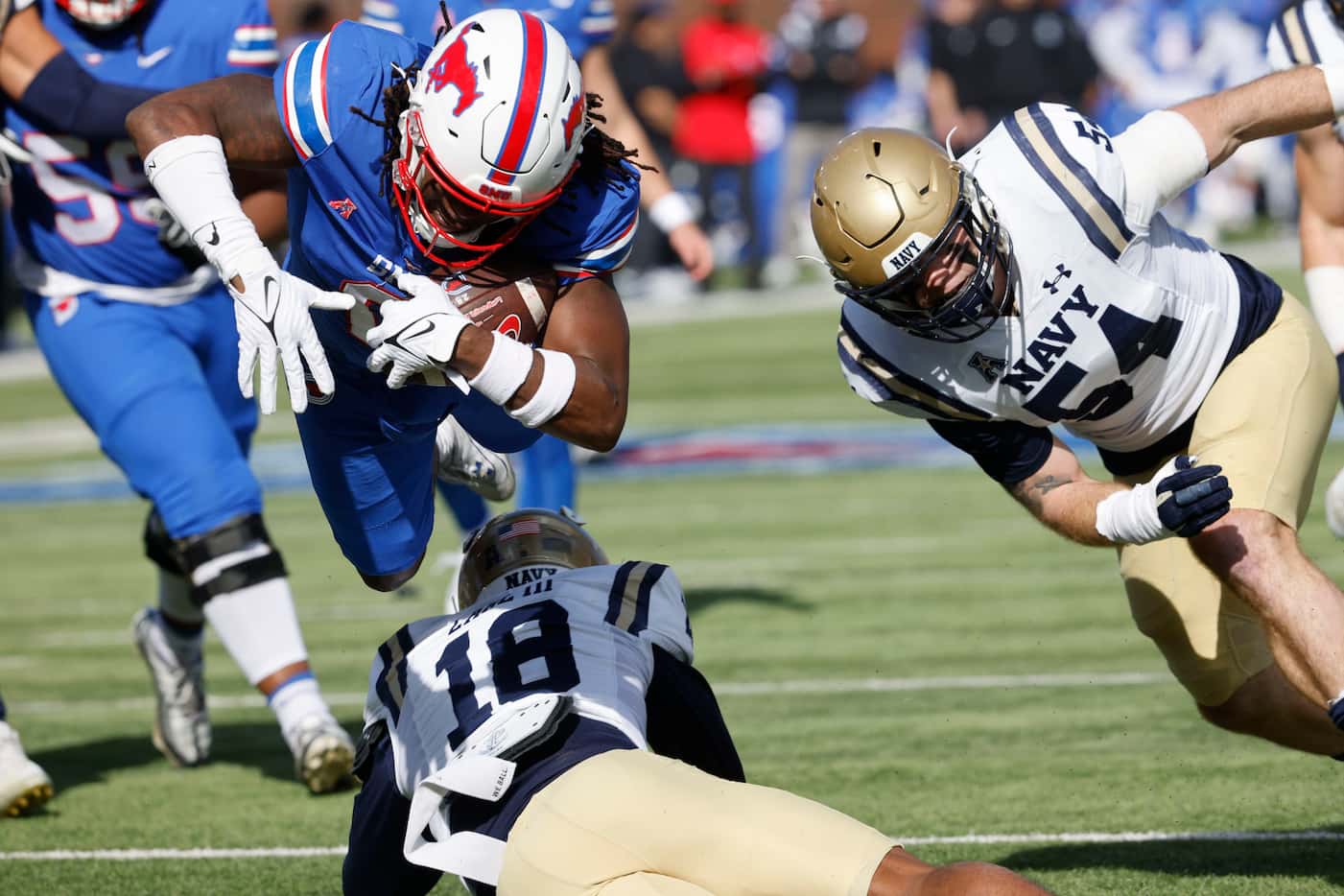 SMU running back Camar Wheaton (0) tries to score a touchdown over Navy safety Rayuan Lane...