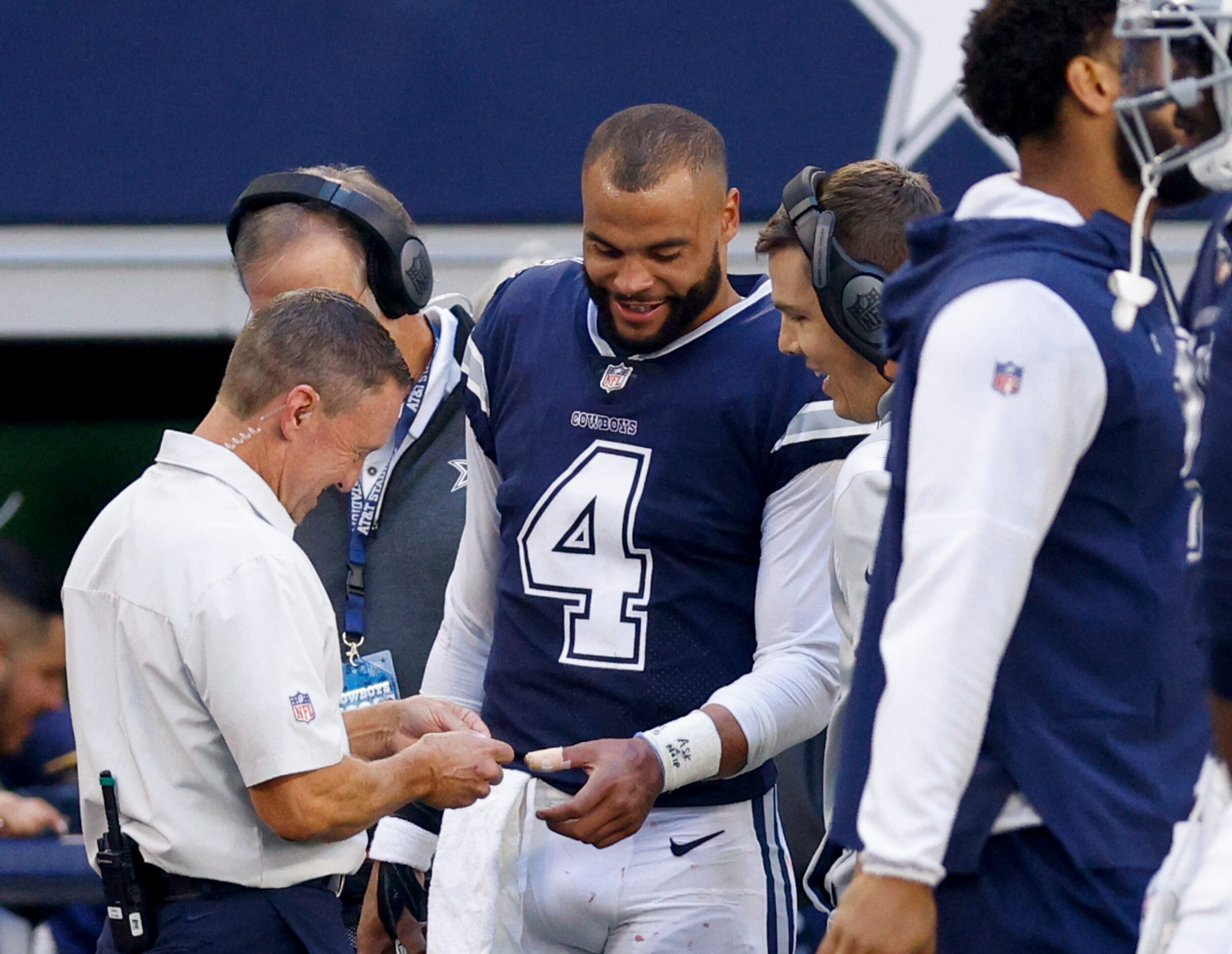 Dallas Cowboys quarterback Dak Prescott (4) has a bandage placed on his hand after he was...