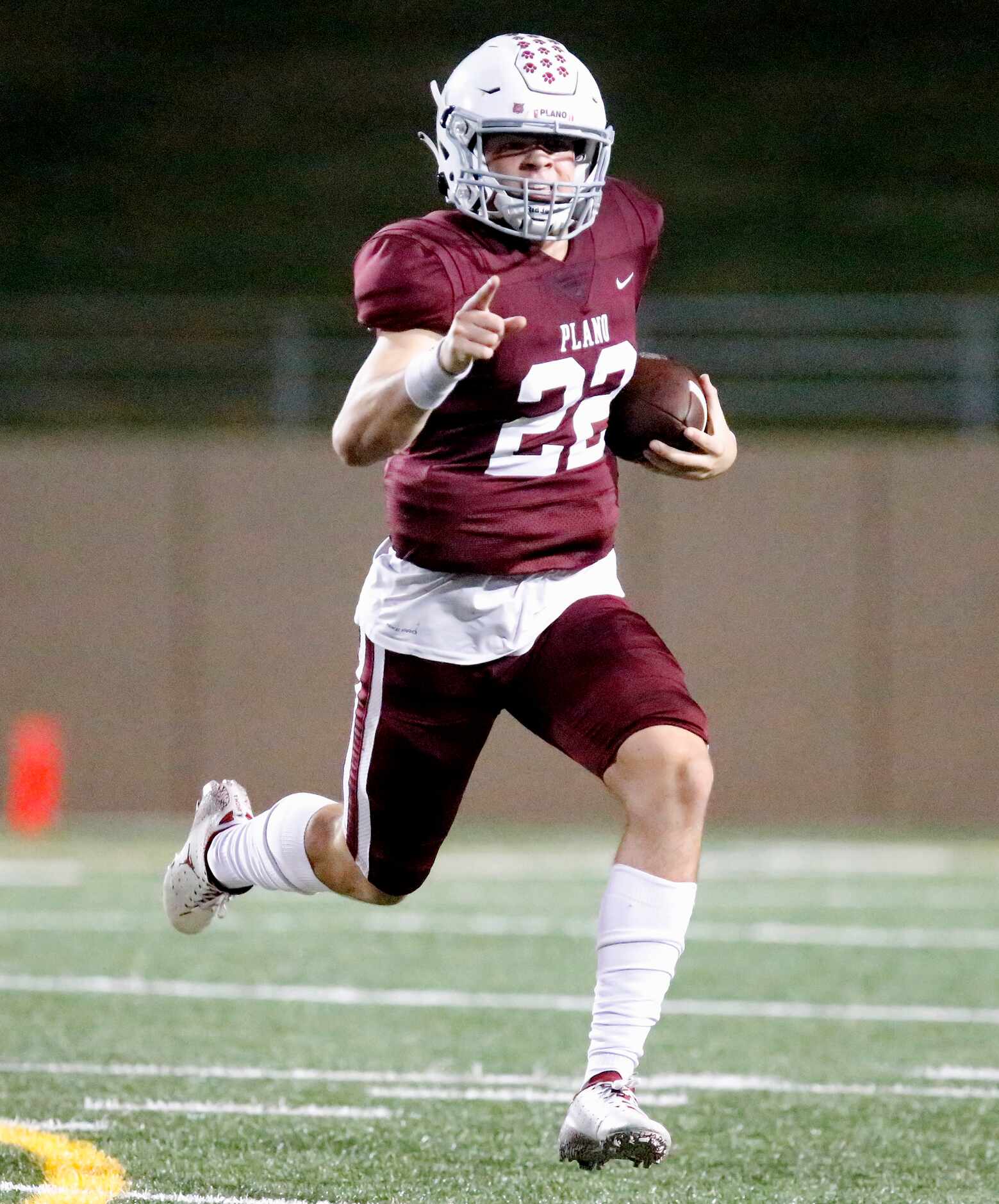 Plano Senior High School quarterback Drew Forkner (22) runs with the ball during the first...