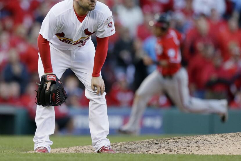  Cardinals pitcher Marc Rzepczynski reacts after giving up a two-run double to Washington's...