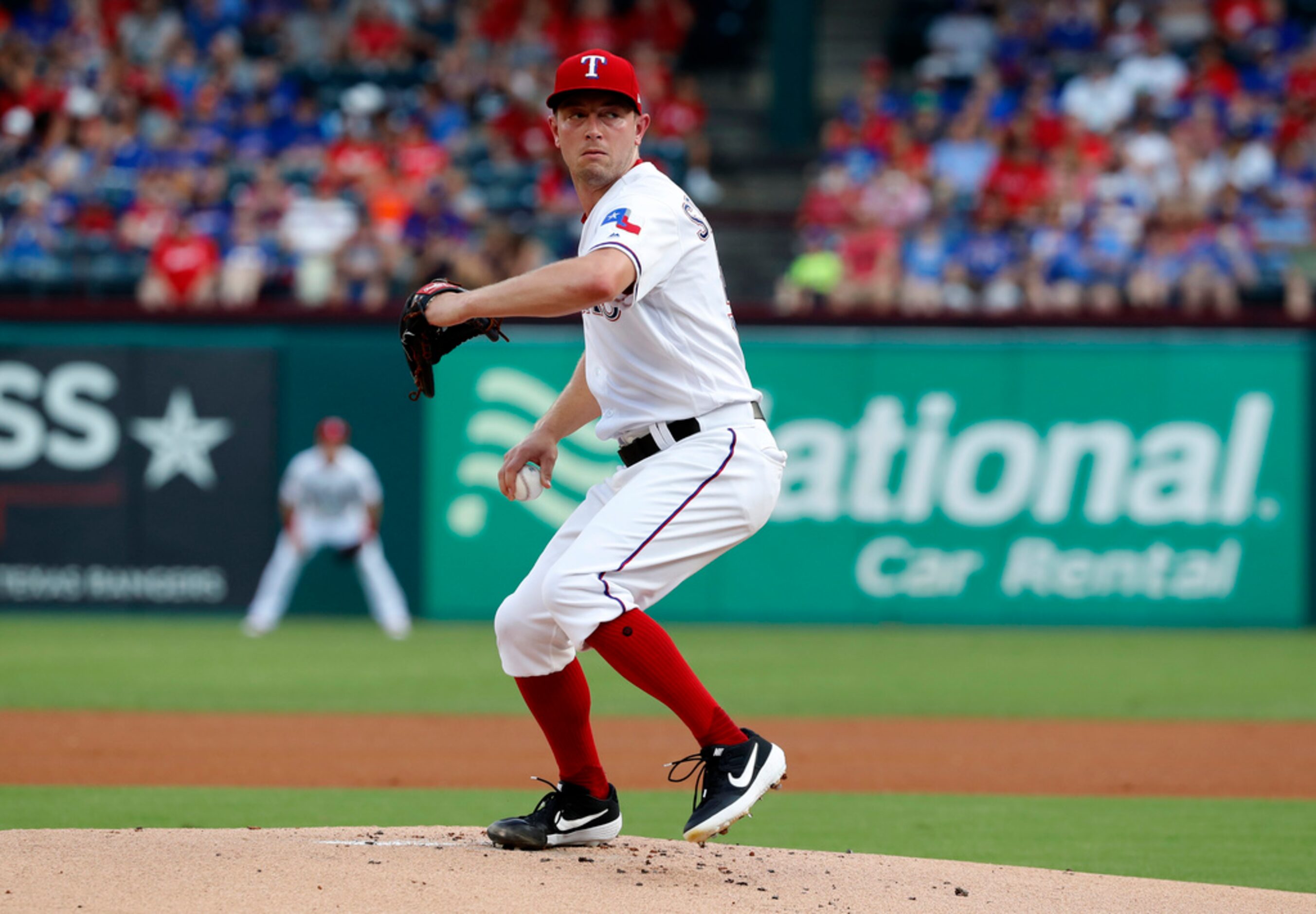 Texas Rangers' Adrian Sampson winds up to throw to the Detroit Tigers in the first inning of...