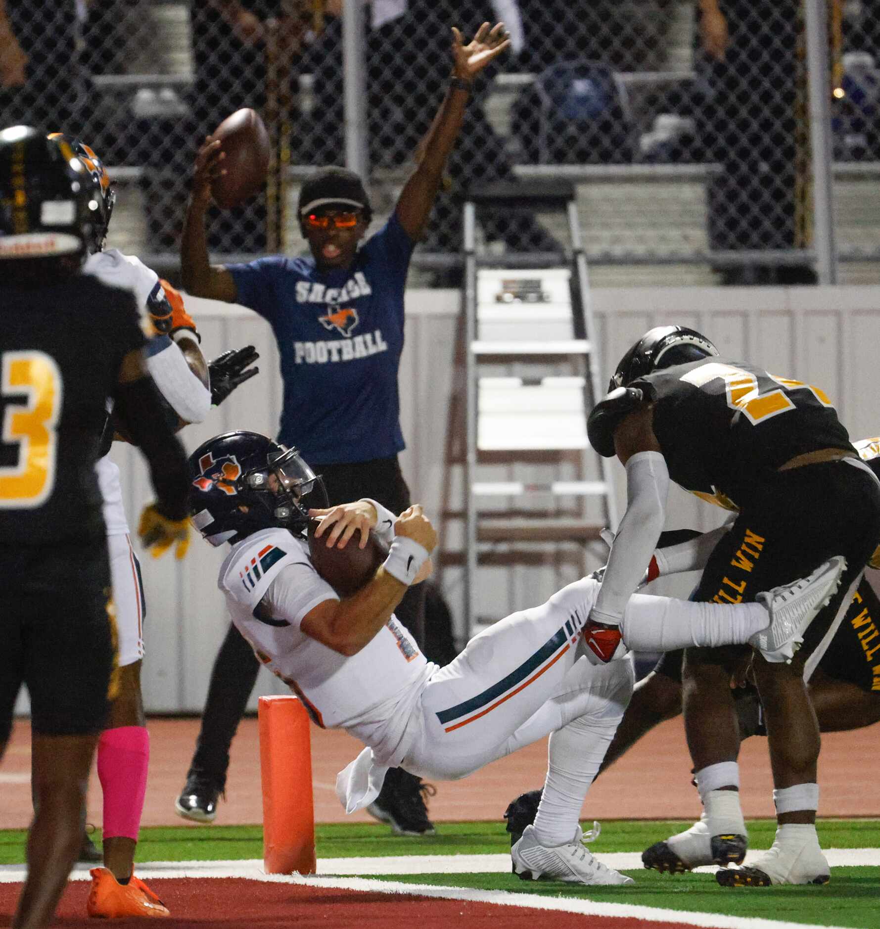 Sachse High School QB Brenden George scores a touchdown during the second half of a football...