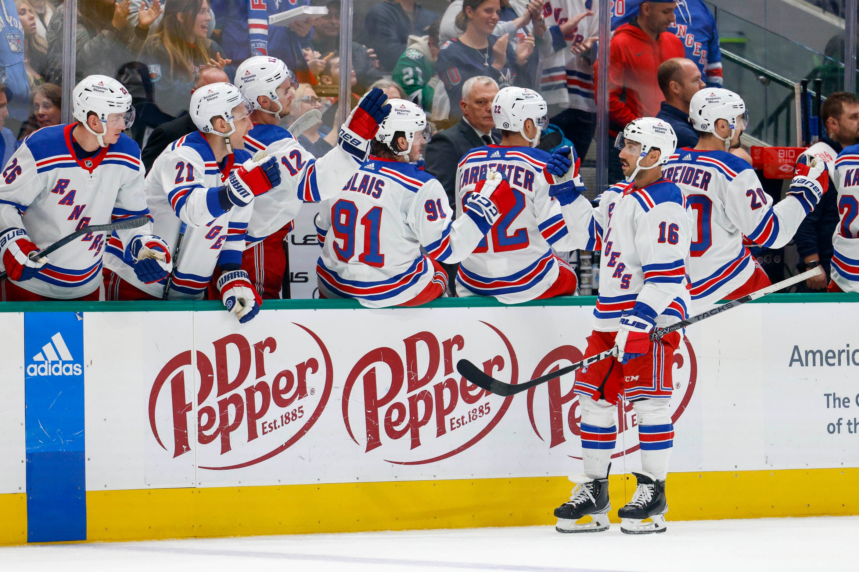 New York Rangers center Vincent Trocheck (16) celebrates with teammates after scoring a goal...