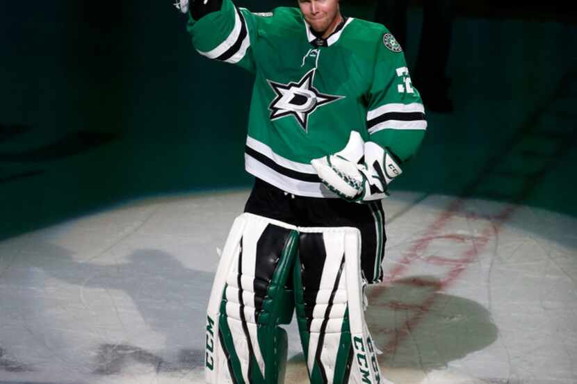 Dallas Stars goaltender Kari Lehtonen (32) reacts to cheers from fans after an overtime win...