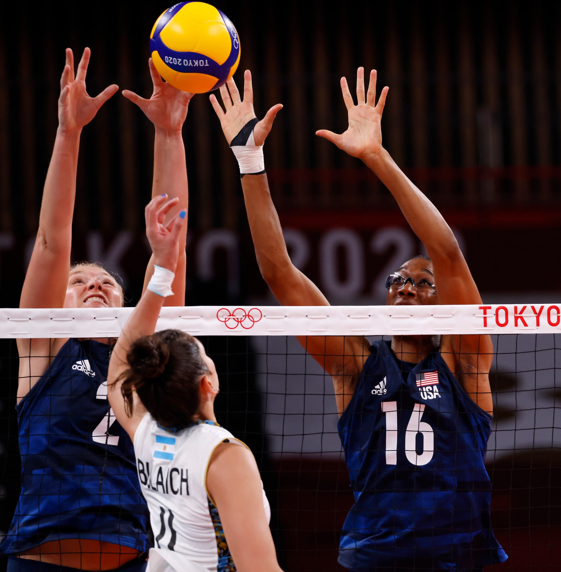 USA’s Jordyn Poulter (2) and Foluke Akinradewo (16) prepare to block a ball hit by...