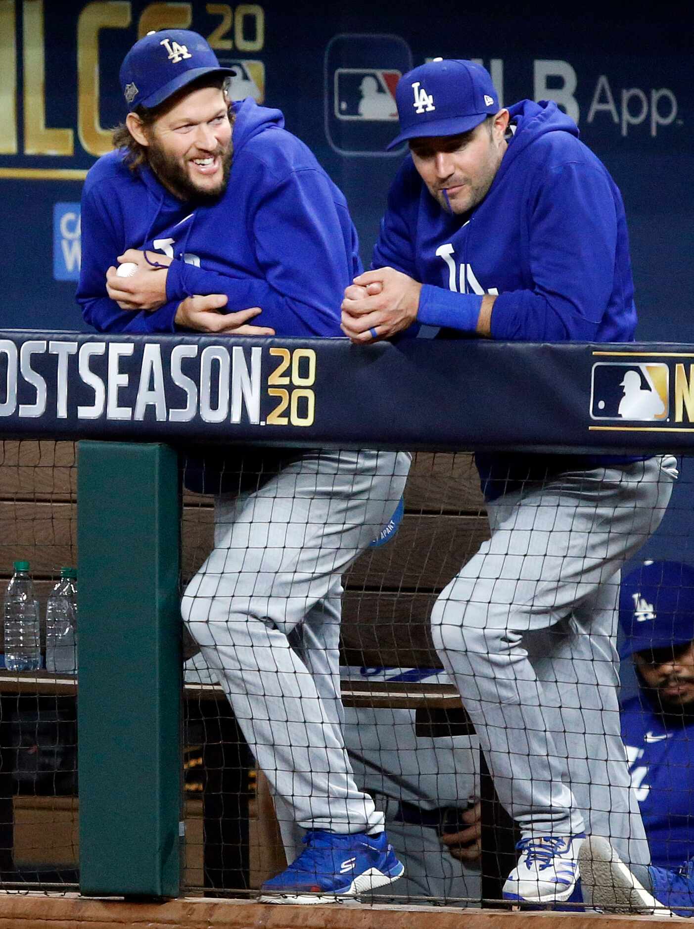 Los Angeles Dodgers starting pitcher Clayton Kershaw (left) visits with a teammate during...