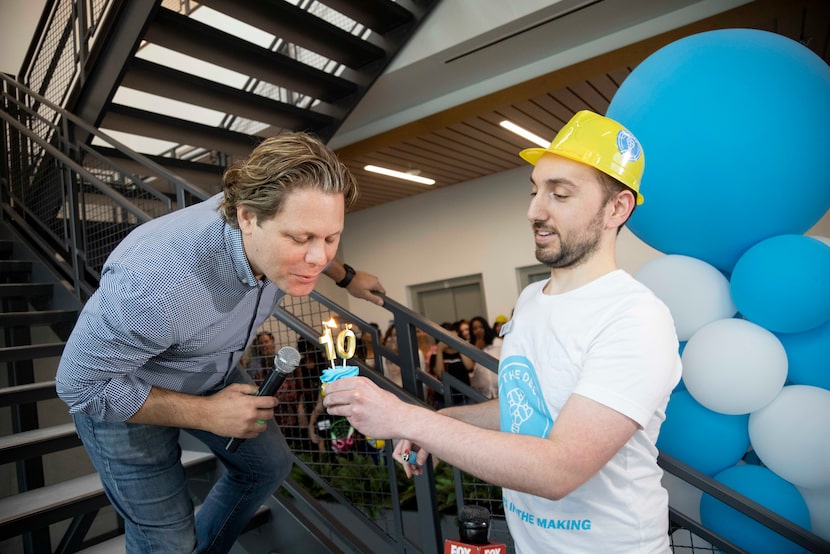 DEC Network co-founder and executive chairman Trey Bowles blows out candles while...