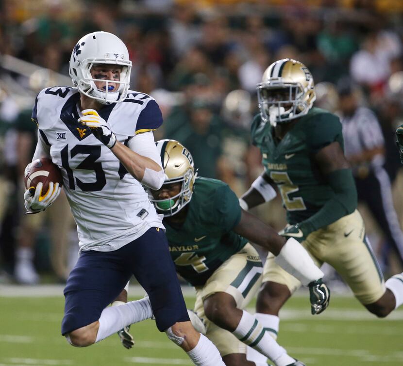 FILE - In this Oct. 21, 2017, file photo, West Virginia wide receiver David Sills V, left,...