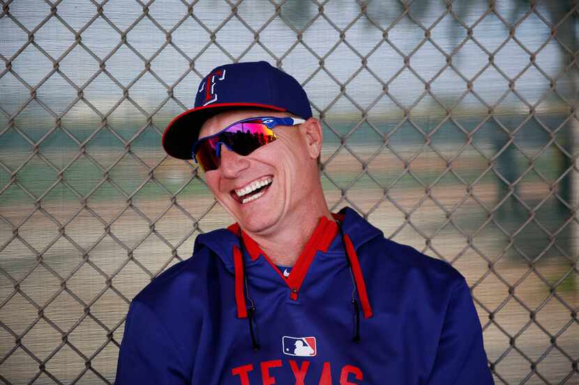 Texas Rangers manager Jeff Banister laughs while speaking to the media during a workout at...