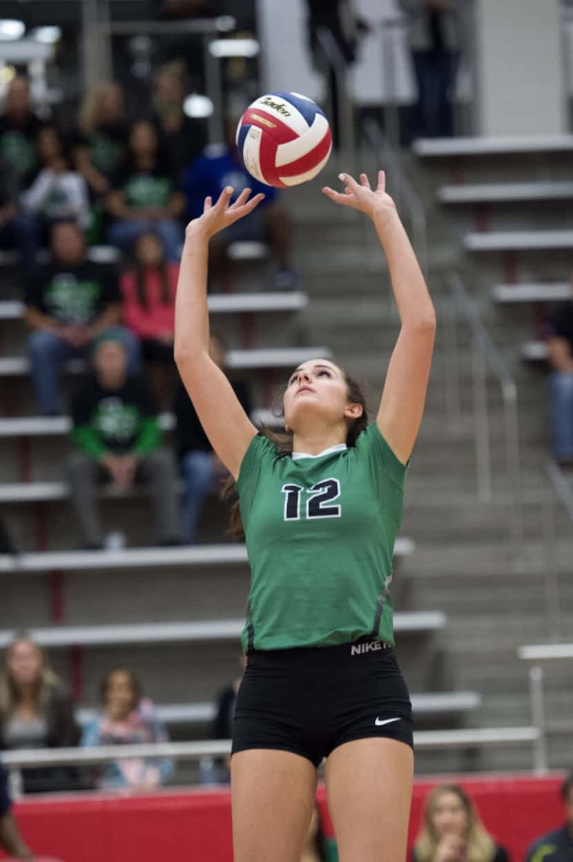 Southlake Carroll junior setter Lisie Kit sets the ball during a playoff volleyball game...