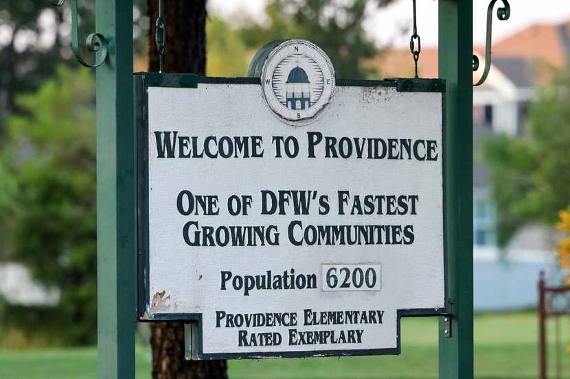 A sign welcomes people to Providence Village. The community's homeownership association drew...
